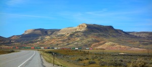 One of those lovely Montana buttes. This was on Highway 15, on the way from Pocatello, Idaho to Missoula.  It looks like a colored pencil drawing, and the colorful train just makes the mountain that much more unreal.